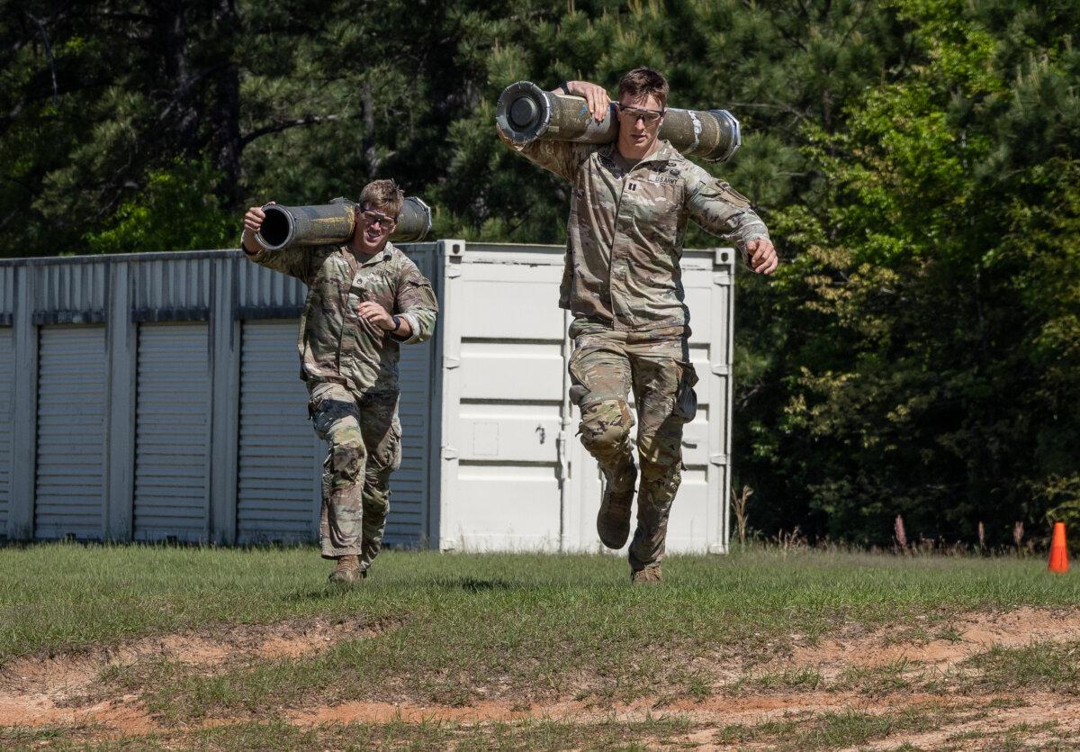 Competitors in the 2026 Best Ranger Competition run through a course at Fort Benning, Ga., on April 10, 2026. (John Fredricks/The Epoch Times)