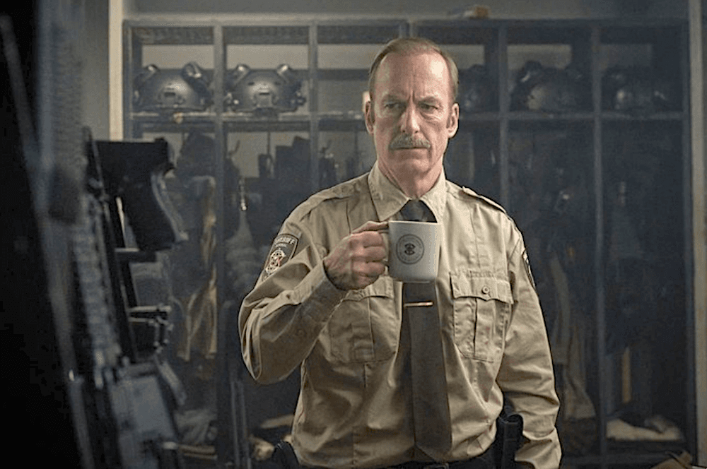 Interim Sheriff Ulysses Richardson (Bob Odenkirk) making a mental note to inform station personnel that one should not be able to simply stroll into the armory any time they please, in "Normal." (Magnolia Pictures)