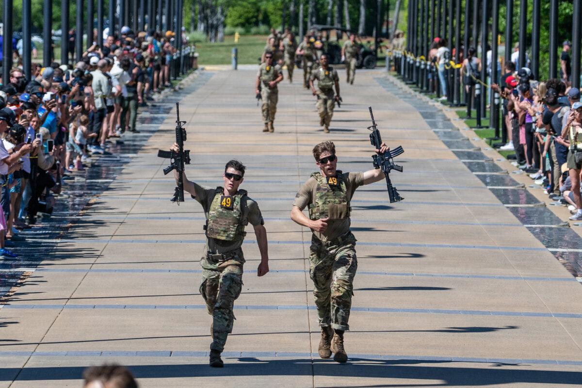 Spc. Caleb Godbold (L) and Sgt. Drew Schorsch (R), representing the 75th Ranger Regiment, cross the finish line at the National Infantry Museum in Columbus, Ga., to complete the Best Ranger Competition on April 12, 2026. (U.S. Army/Patrick A. Albright)