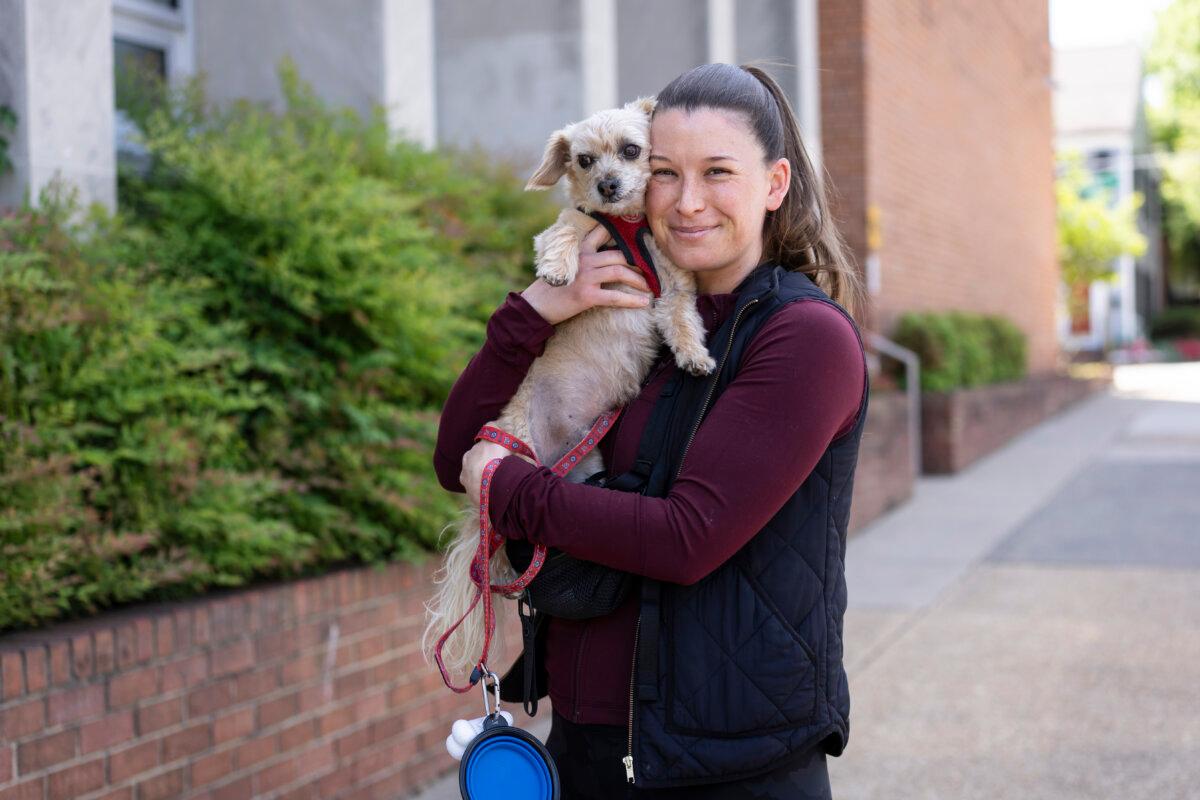 Lara Meehan and her dog Gigi after voting in the redistricting referendum in Alexandria, Va., on April 21, 2026. (Madalina Kilroy/The Epoch Times)