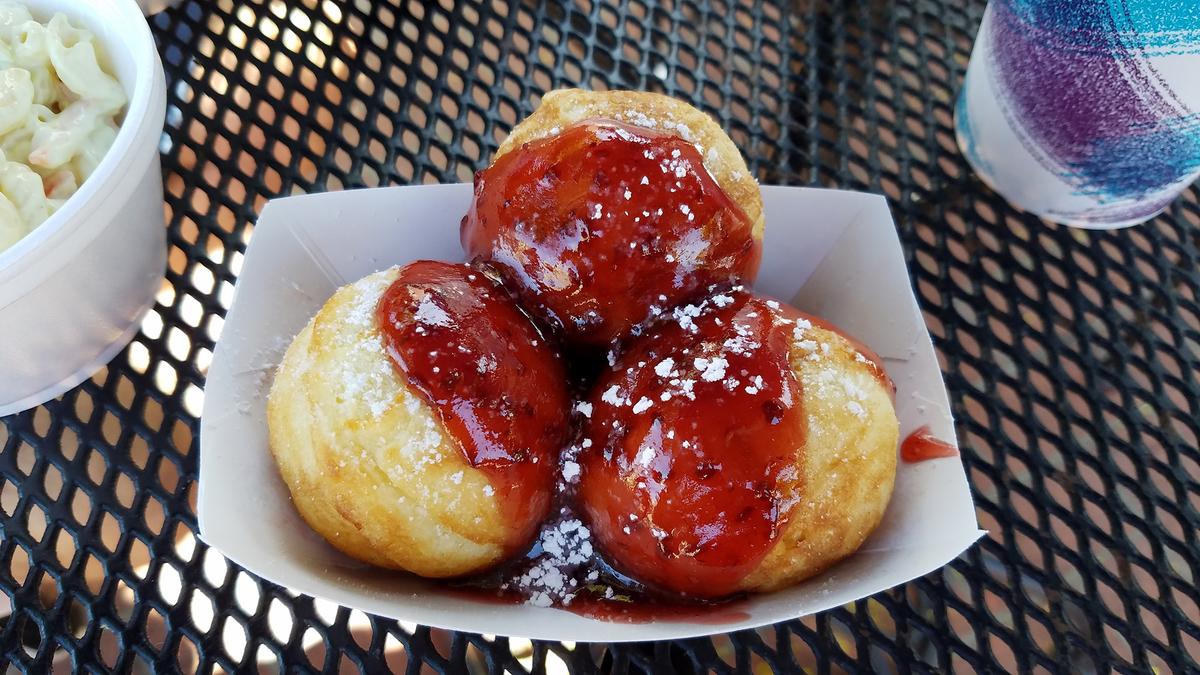 Abelskivers, Danish pancake balls, are cooked in a cast-iron pan until light and fluffy, then served warm with powdered sugar and syrup or jam. (Brian Roeder/Shutterstock)