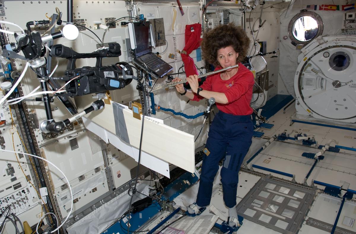 In her downtime, NASA astronaut Cady Coleman (Expedition 27 flight engineer), plays a flute in the JAXA Kibo laboratory onboard the International Space Station, 2011. (NASA)