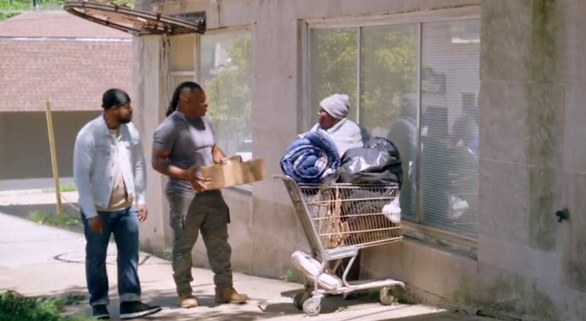 Brian (Stephen Wesley Green, L) with Samuel (Curtis Nichouls), who is handing out food, in “Grace Wins.” (GJW+)