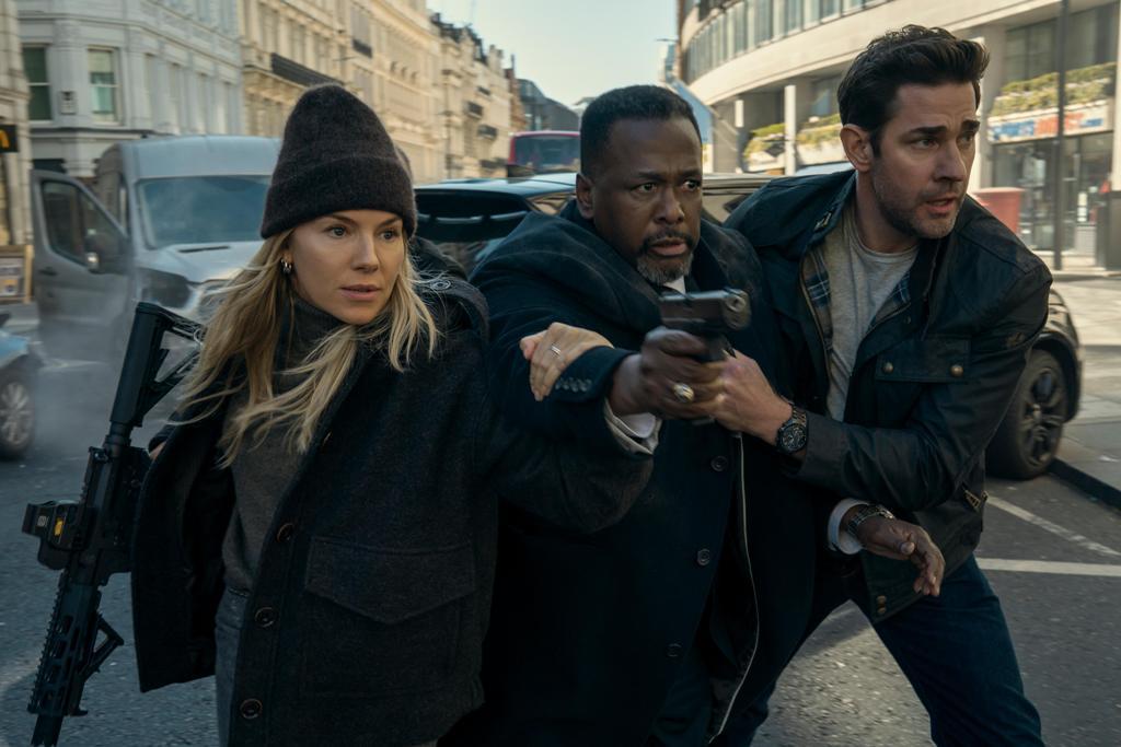 (L-R) Emma Marlow (Sienna Miller), James Greer (Wendell Pierce), and Jack Ryan (John Krasinski), in an action scene from "Jack Ryan: Ghost War." (Amazon/MGM Studios)