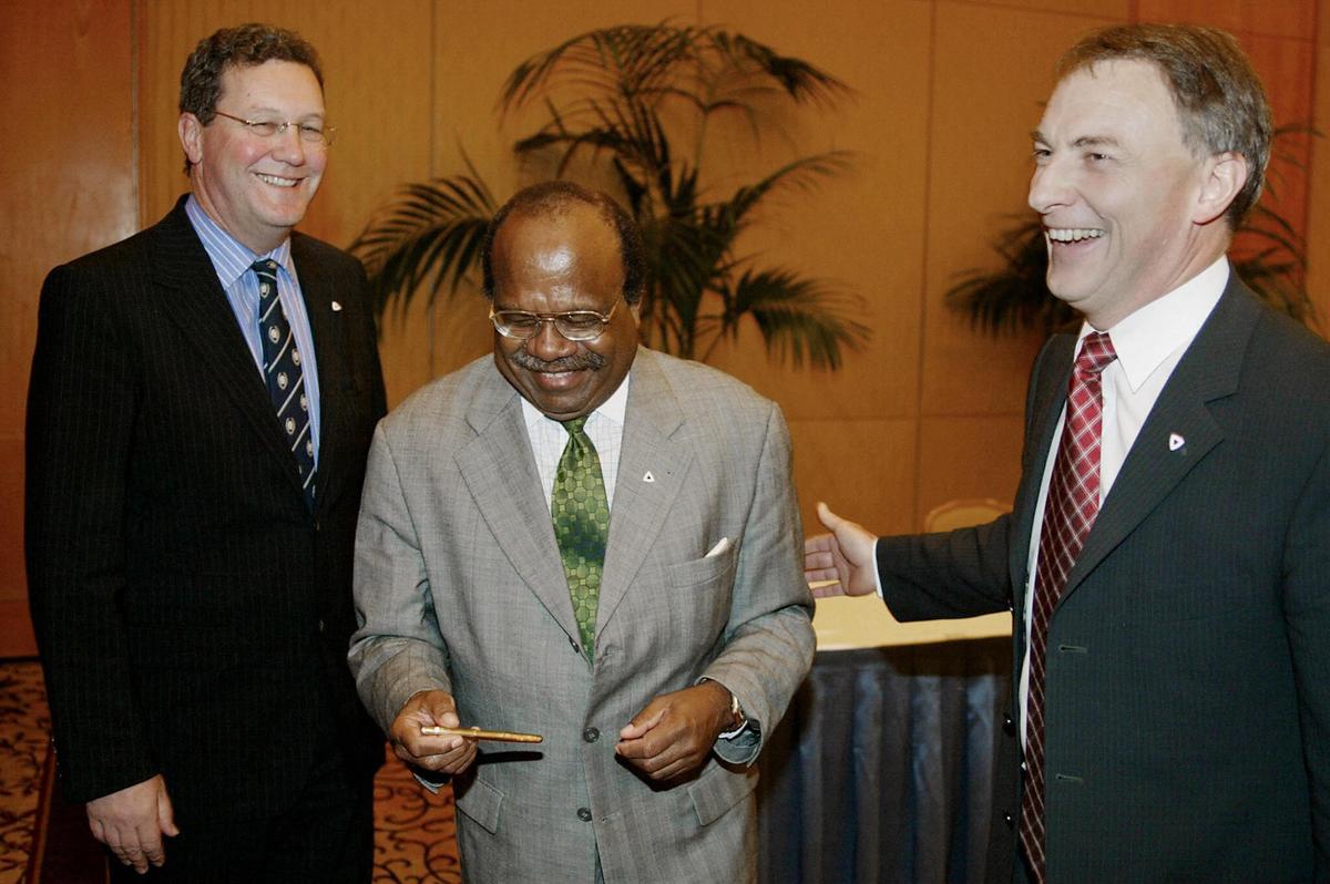 Australian Foreign Minister Alexander Downer (L) and New Zealand Minister for Foreign Affairs Phil Goff (R) share a joke with Papua New Guinea's Minister for Foreign Affairs Sir Rabbie Namaliu (C) after signing an agreement to formally establish the Bougainville Transition Team at a Pacific Islands Forum in Sydney, on June 30, June 2003. (Mark Baker/AFP via Getty Images)