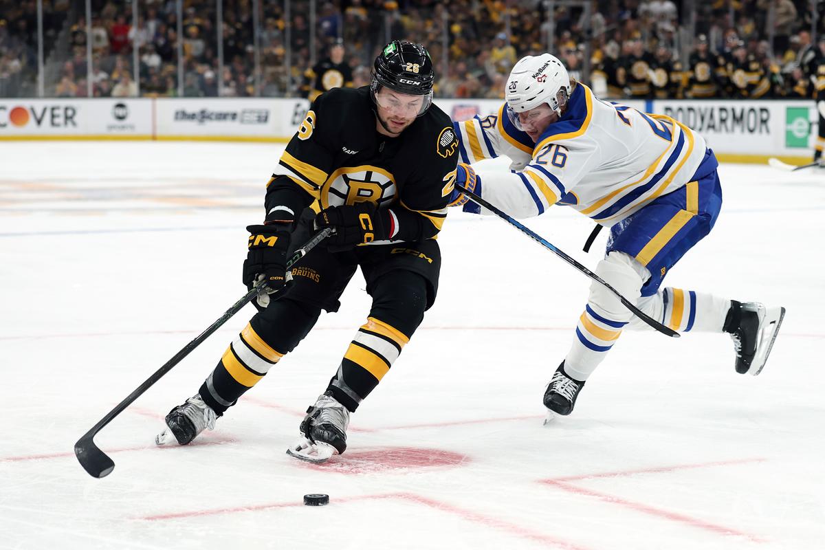 Andrew Peeke #26 of the Boston Bruins skates past Rasmus Dahlin #26 of the Buffalo Sabres during the third period in Game 3 of the First Round of the 2026 Stanley Cup Playoffs at TD Garden in Boston, Mass., on April 23, 2026. (Maddie Meyer/Getty Images)