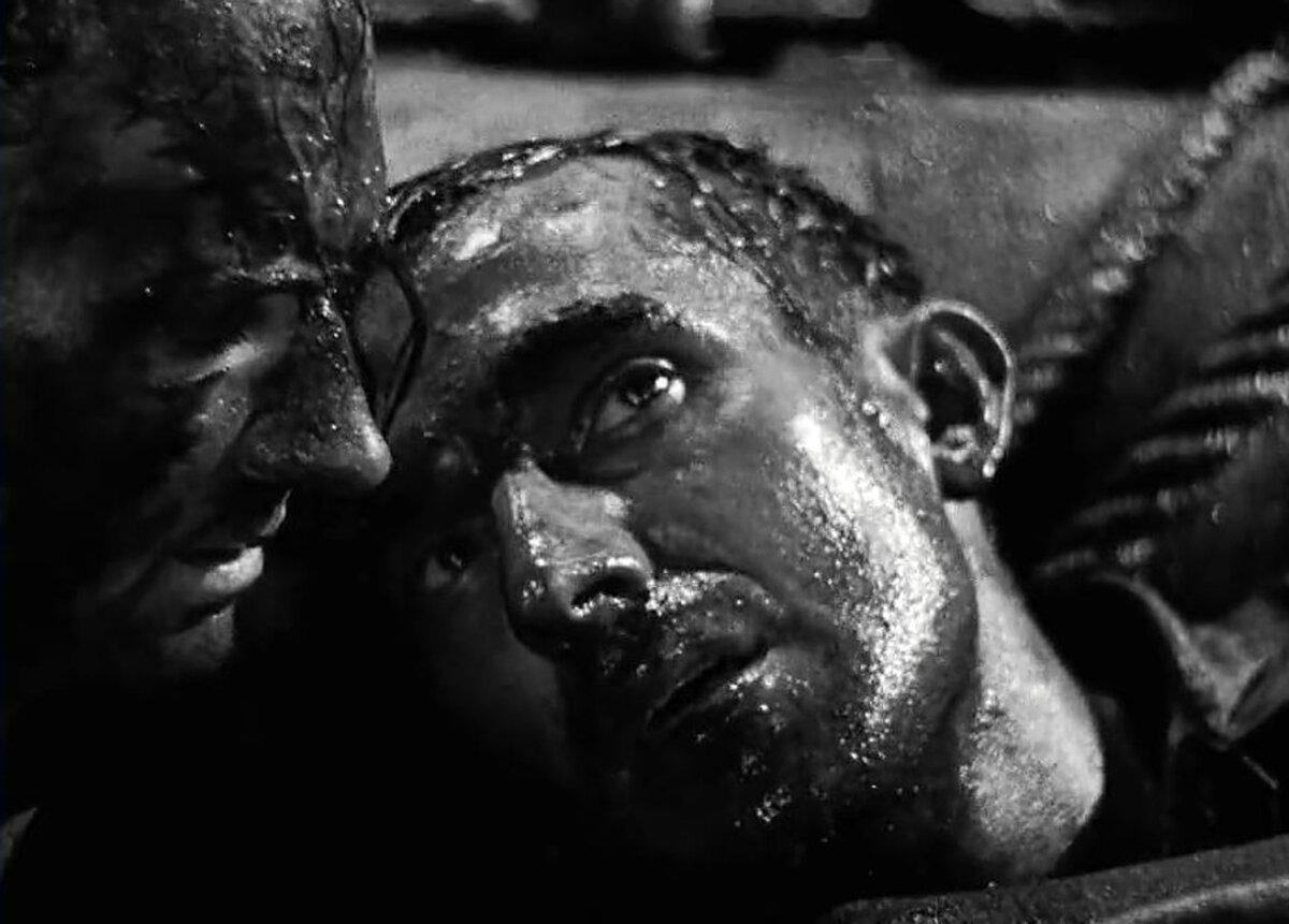 Edgecombe (Frederick Piper, L) and Chief Petty Officer Walter Hardy (Bernard Miles) are stranded at sea, in “In Which We Serve.” (British Lion Films)