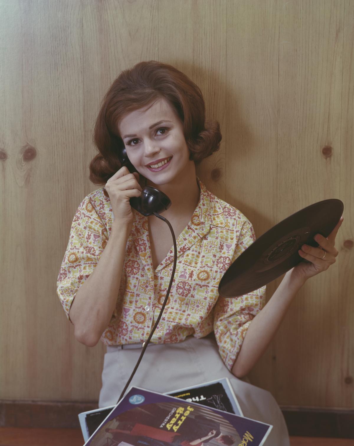 A young woman makes a phone call while holding an album by the Jerry Gray Orchestra, circa 1955. The 1950s and 1960s are often regarded as the golden age of vinyl records. (Archive Photos/Getty Images)