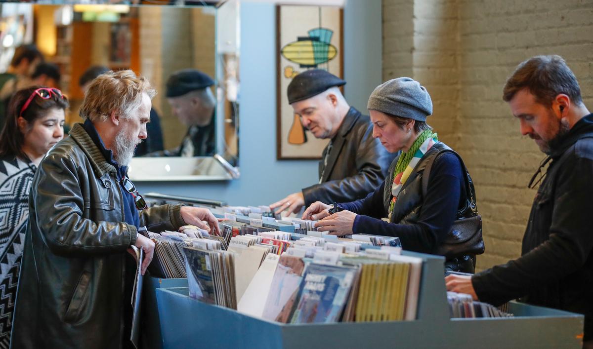 Customers shop for special edition vinyl records at Dusty Groove music store during the Record Store Day in Chicago on April 13, 2019. (Kamil Krzaczynksi/Getty Images)
