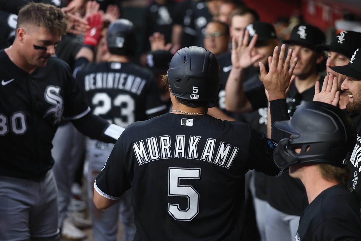 Munetaka Murakami (5) of the Chicago White Sox high fives teammates in the dugout after scoring a run against the Arizona Diamondbacks during the first inning of the MLB game at Chase Field in Phoenix, Arizona on April 21, 2026. (Christian Petersen/Getty Images)