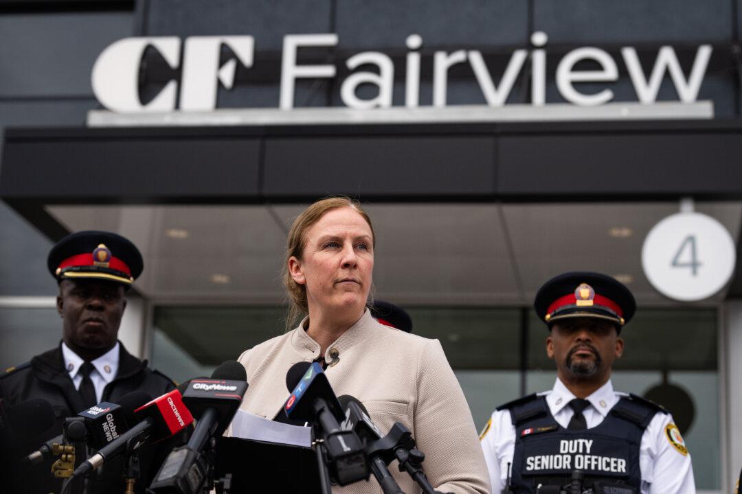 Police Offer Reward in Search for Suspect in Robberies, Shooting