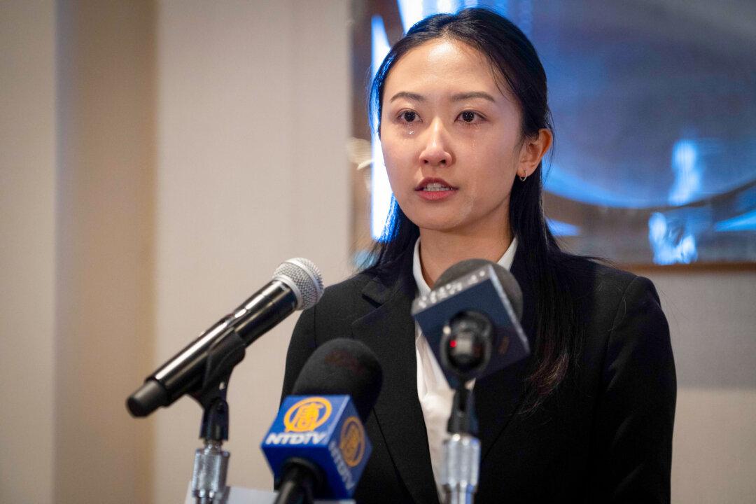 Shen Yun emcee Nancy Zhang becomes emotional as she recounts the CCP’s persecution of her family for practicing Falun Dafa at a press conference in Toronto on April 2, 2026. (Evan Ning/The Epoch Times)
