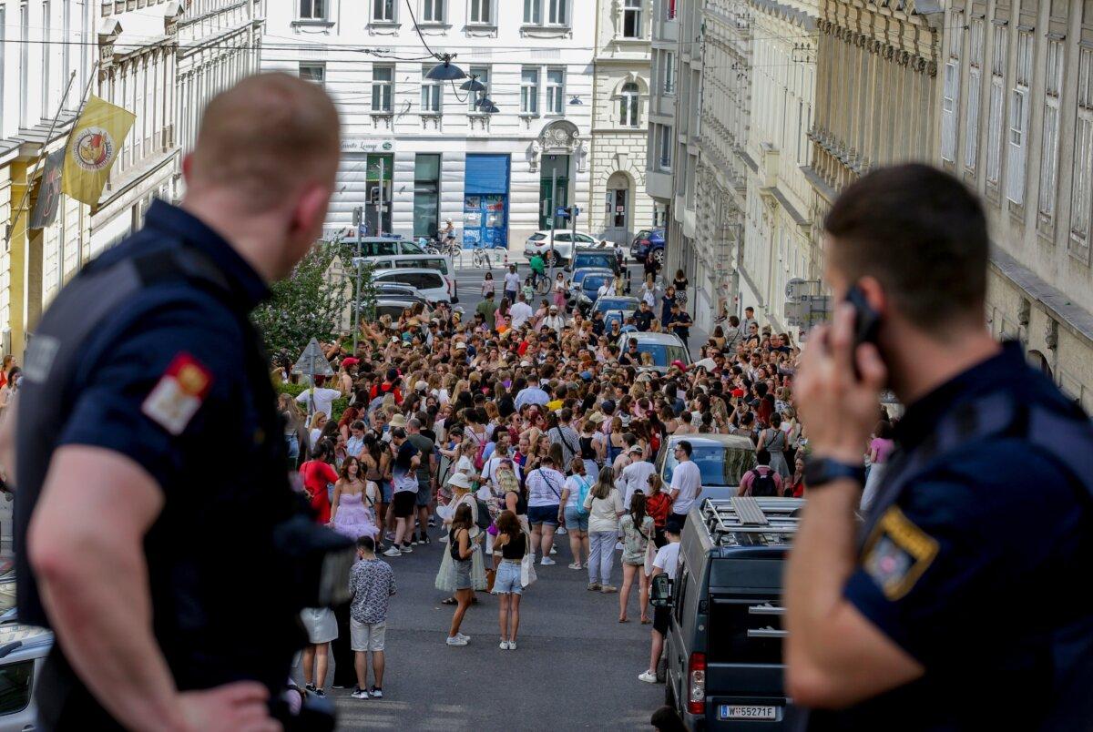 Austrian police officers watch a gathering of Taylor Swift fans in the city center in Vienna on Aug. 8, 2024. (Heinz-Peter Bader/AP Photo)