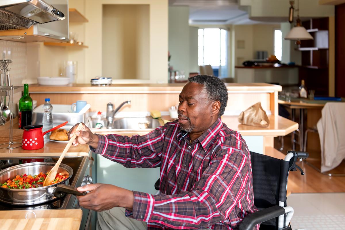 Lowering the countertops a few inches and widening circulation spaces make the kitchen more wheelchair-accessible. (RealPeopleGroup/Getty Images)