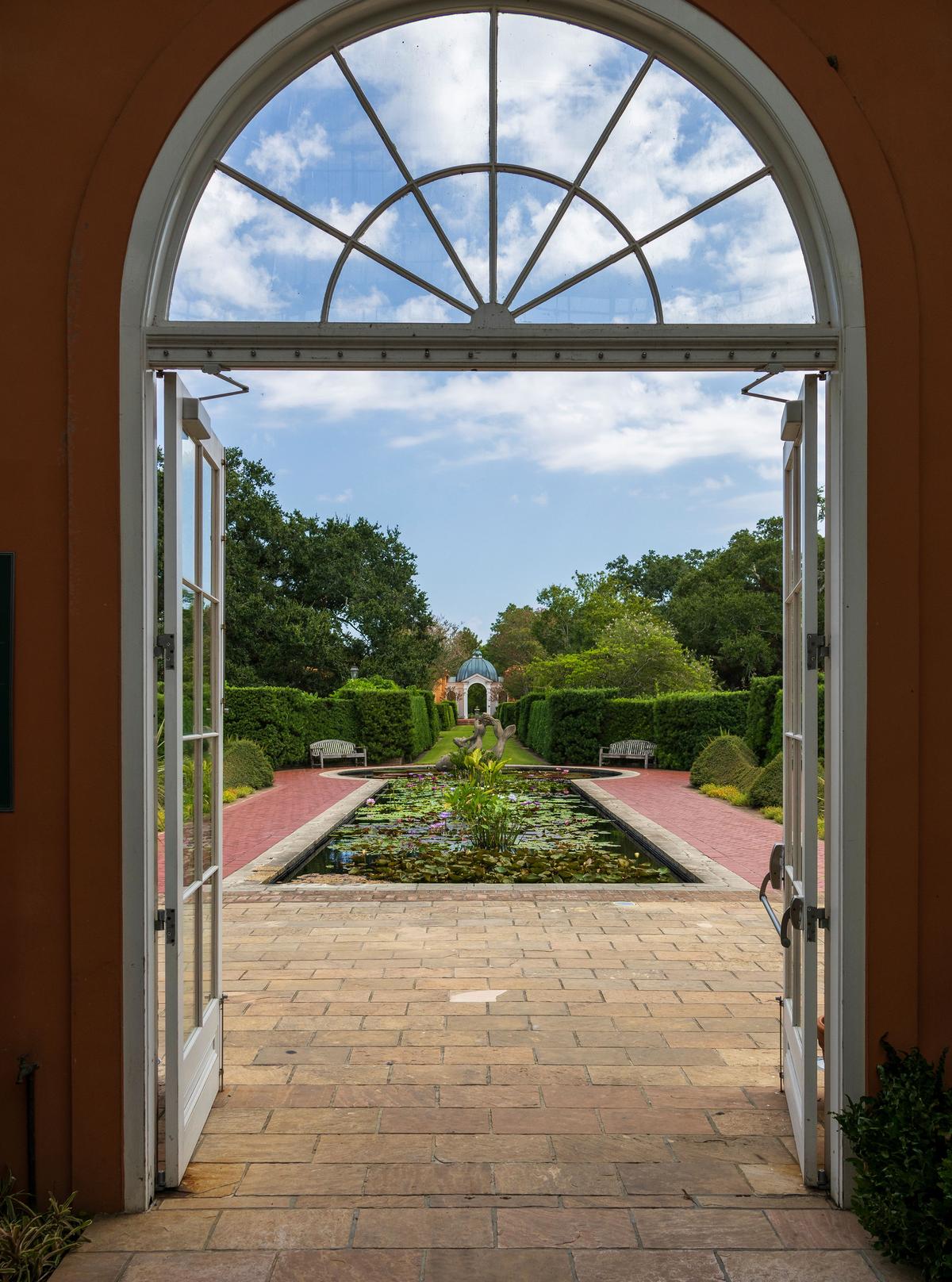 Fanlight windows and French doors open from the conservatory’s domed entrance onto the Lily Pond, a quintessential French garden focal point. Its long rectangular water feature, anchored by a classical Undine sculpture, emphasizes elegance and symmetry. Four formal rose beds frame the pond, while vibrant seasonal water lilies enhance its refined beauty. (Marcus E Jones/Shutterstock)