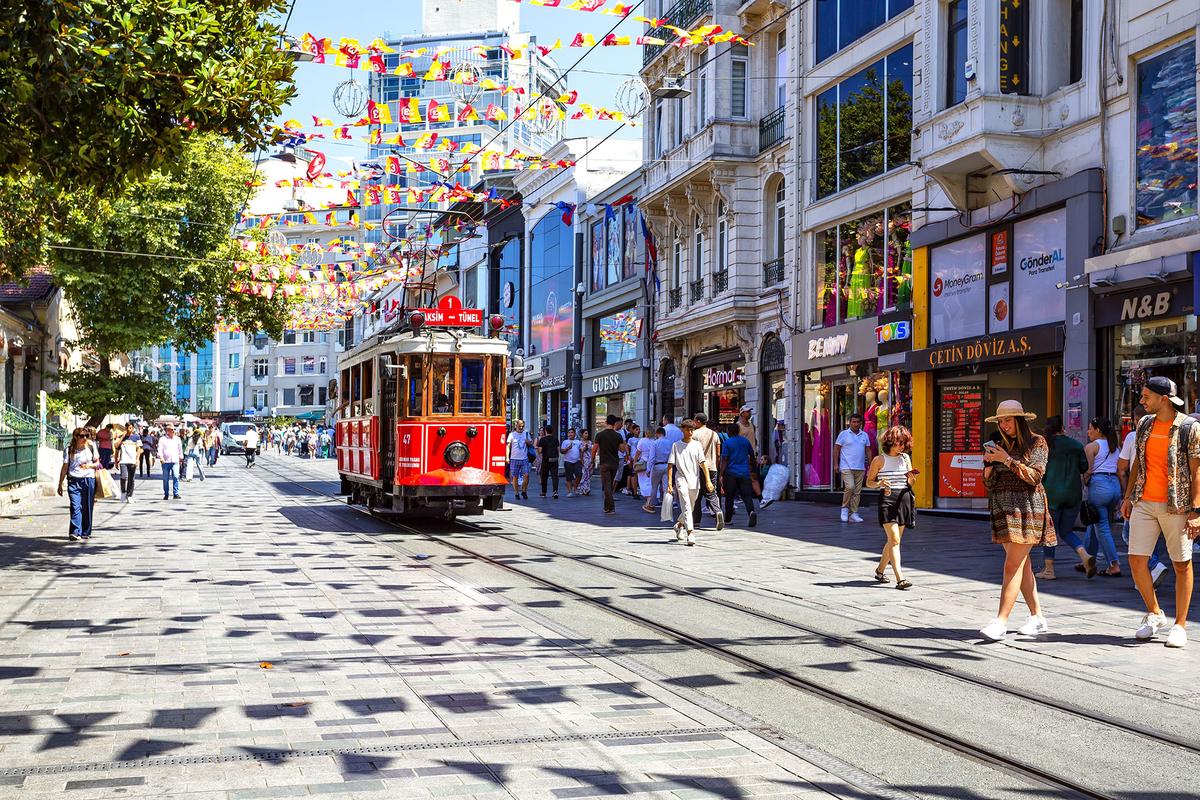 A historic red tram runs along Istiklal Avenue, adding to its distinctive character as a major pedestrian street. (lapas77/Shutterstock)