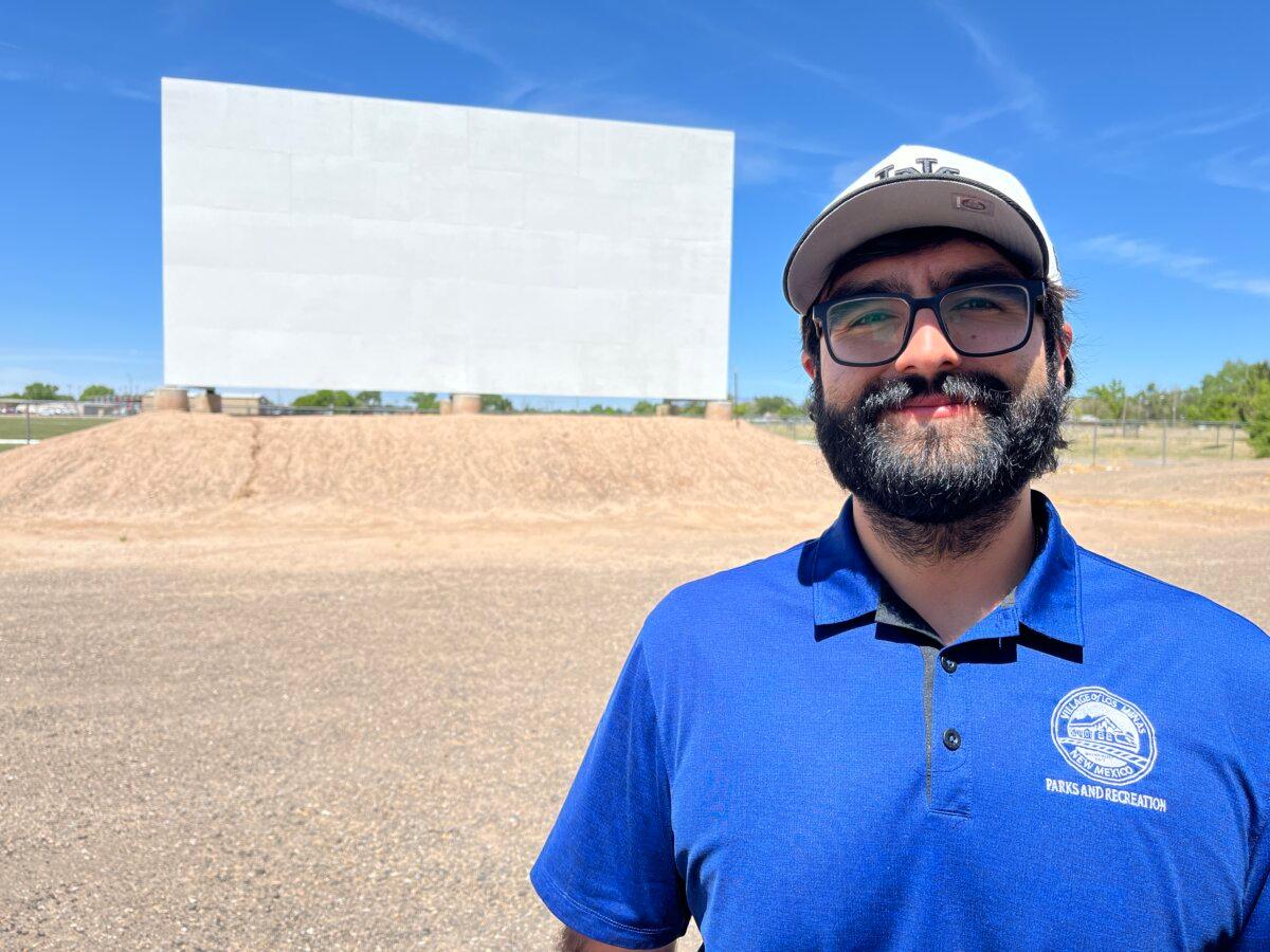 Recreation Supervisor Matthew Jaramillo stands in front of the Badlands Drive-In movie screen in Los Lunas, N.M., on April 24, 2026. (Allan Stein/The Epoch Times)