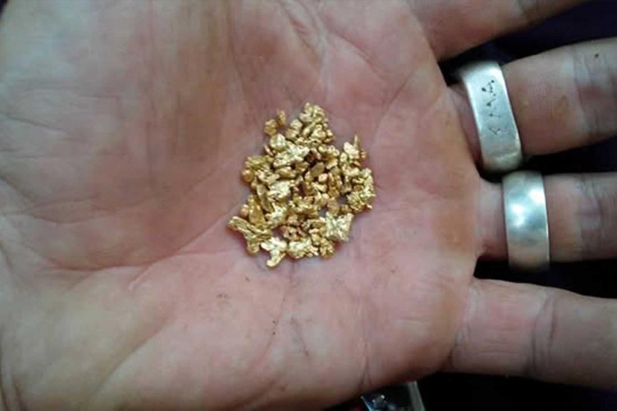 Denig holds gold he found while panning in a river. (Courtesy of Justin Denig)