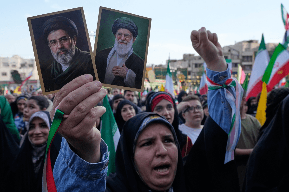 A woman holds up pictures of the Iranian leader Ayatollah Mojtaba Khamenei, left, and his father, the slain Ayatollah Ali Khamenei in a state-organized rally celebrating the birthday of Imam Reza, the 8th Shiite Muslims' imam, and supporting the supreme leader, in Tehran, Iran, on April 29, 2026. (Vahid Salemi/AP Photo)