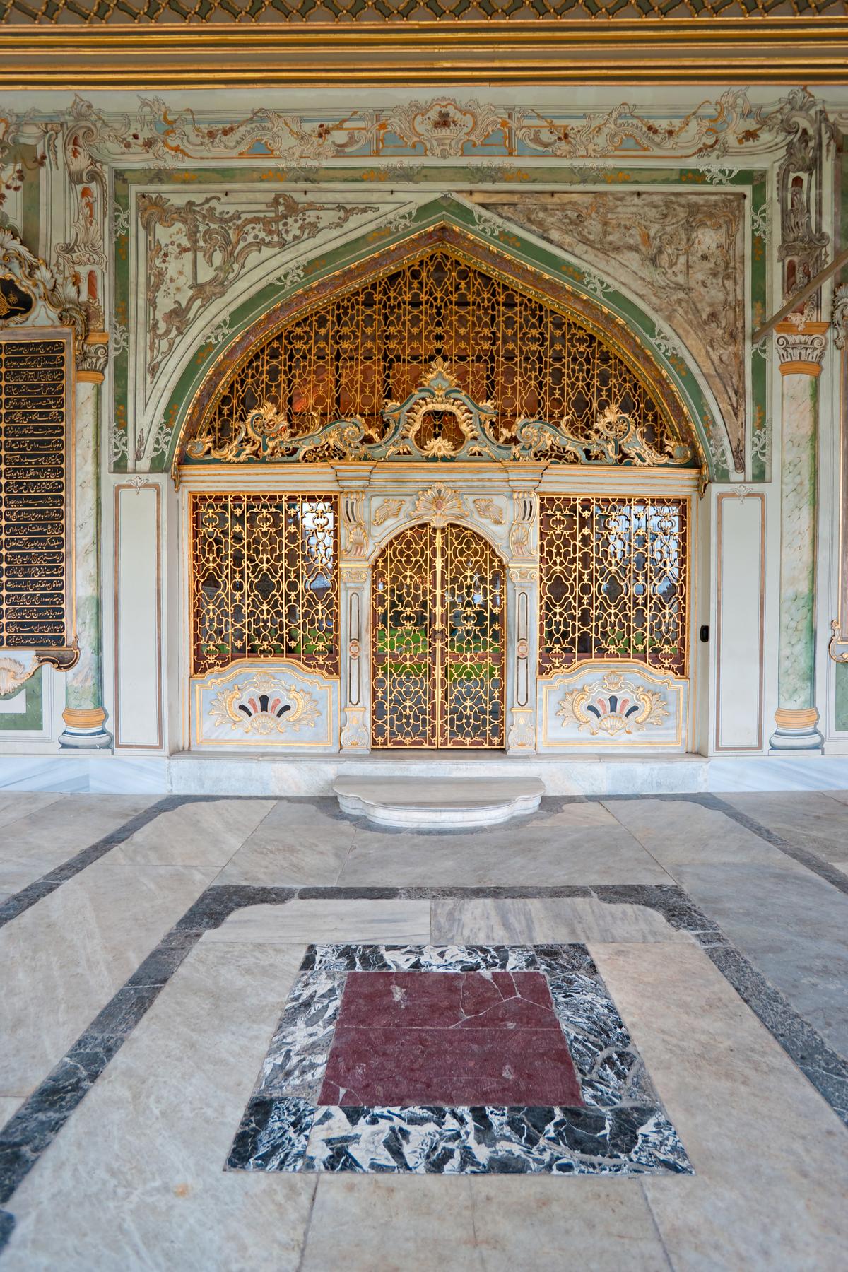This elaborately decorated exterior entrance to the Imperial Council Hall features gilded grills set within embellished walls. It is approached through a porch supported by polished marble and porphyry pillars and crowned with a green-and-white wooden ceiling enriched with gold detailing. (Luciano Mortula - LGM/Shutterstock)