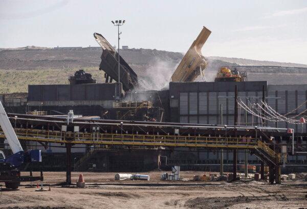 Trucks carry bitumen-rich sand to a crusher for transfer to processing facilities at a Suncor mine in Fort McMurray, Alta., in a file photo. (The Canadian Press/Jason Franson)