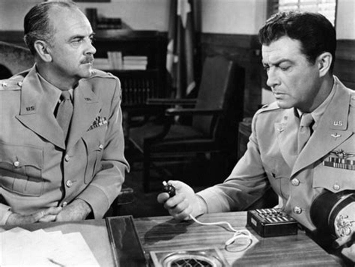 Maj. Gen. Vernon Brent (Larry Keating, L) and Lt. Col. Paul Tibbets (Robert Taylor) must make profound decisions, in “Above and Beyond.” (Metro-Goldwyn-Mayer)