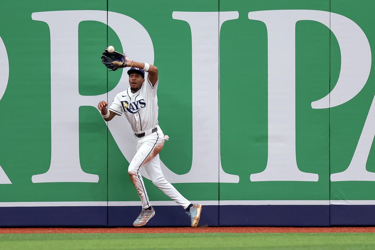 Chandler Simpson #14 of the Tampa Bay Rays makes a catch on a hit by Spencer Steer #7 of the Cincinnati Reds during the seventh inning of a baseball game at Tropicana Field in St. Petersburg, Florida, on April 22, 2026. (Mike Carlson/Getty Images)