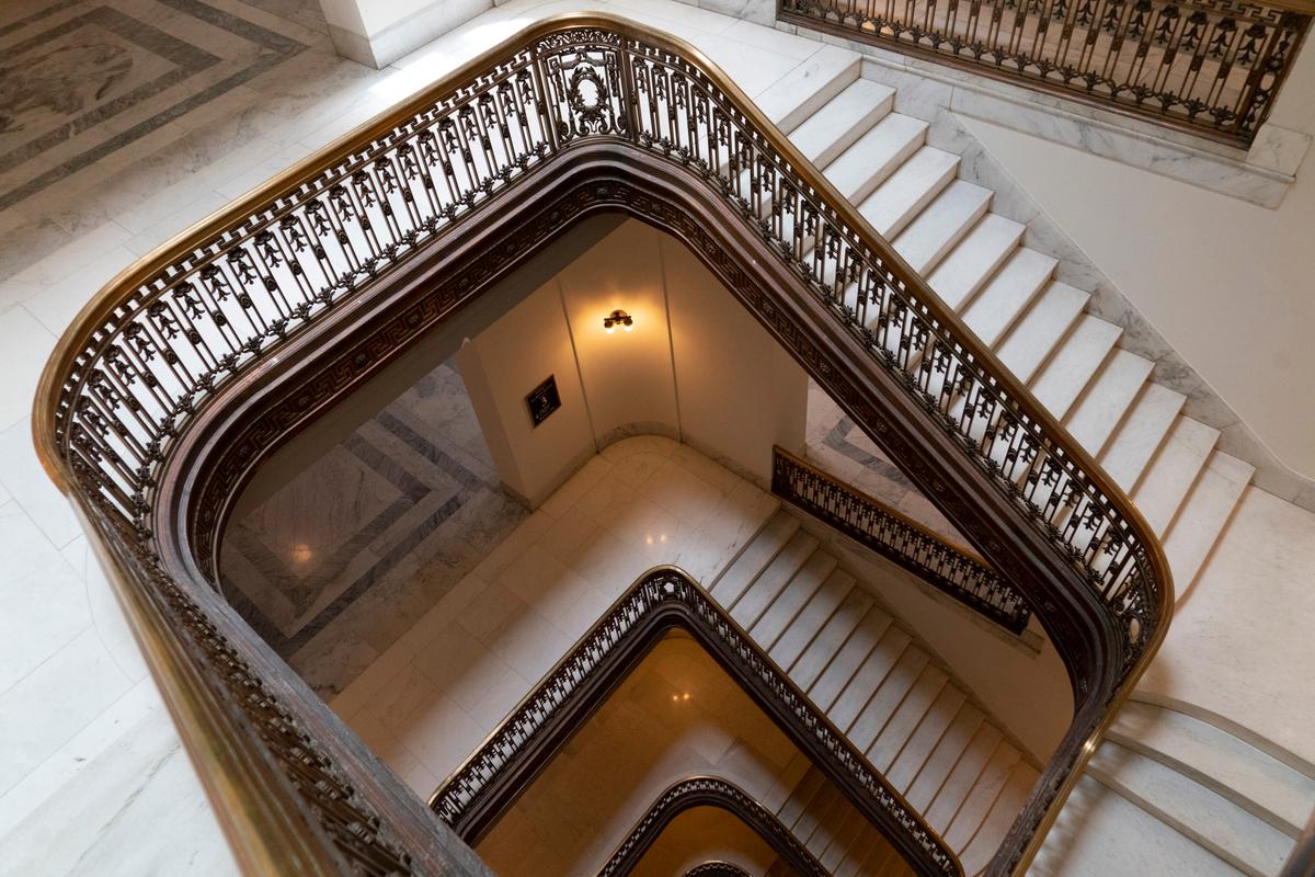 Bronze railings with uniquely embellished balusters adorn the square-shaped marble staircases that lead from the main rotunda floor to the elaborate Kennedy Caucus Room. Corner, curvature sections of each level of the staircase features a wreath and swag design. (Andrea Izzotti/Shutterstock)