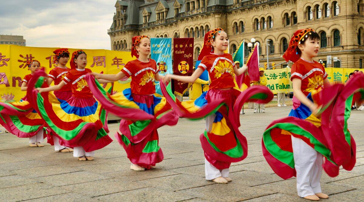 Young Falun Dafa practitioners hold a dance performance as part of activities to celebrate the World Falun Dafa Day on Parliament Hill, Ottawa, on May 5, 2026. (Jonathan Ren/The Epoch Times)