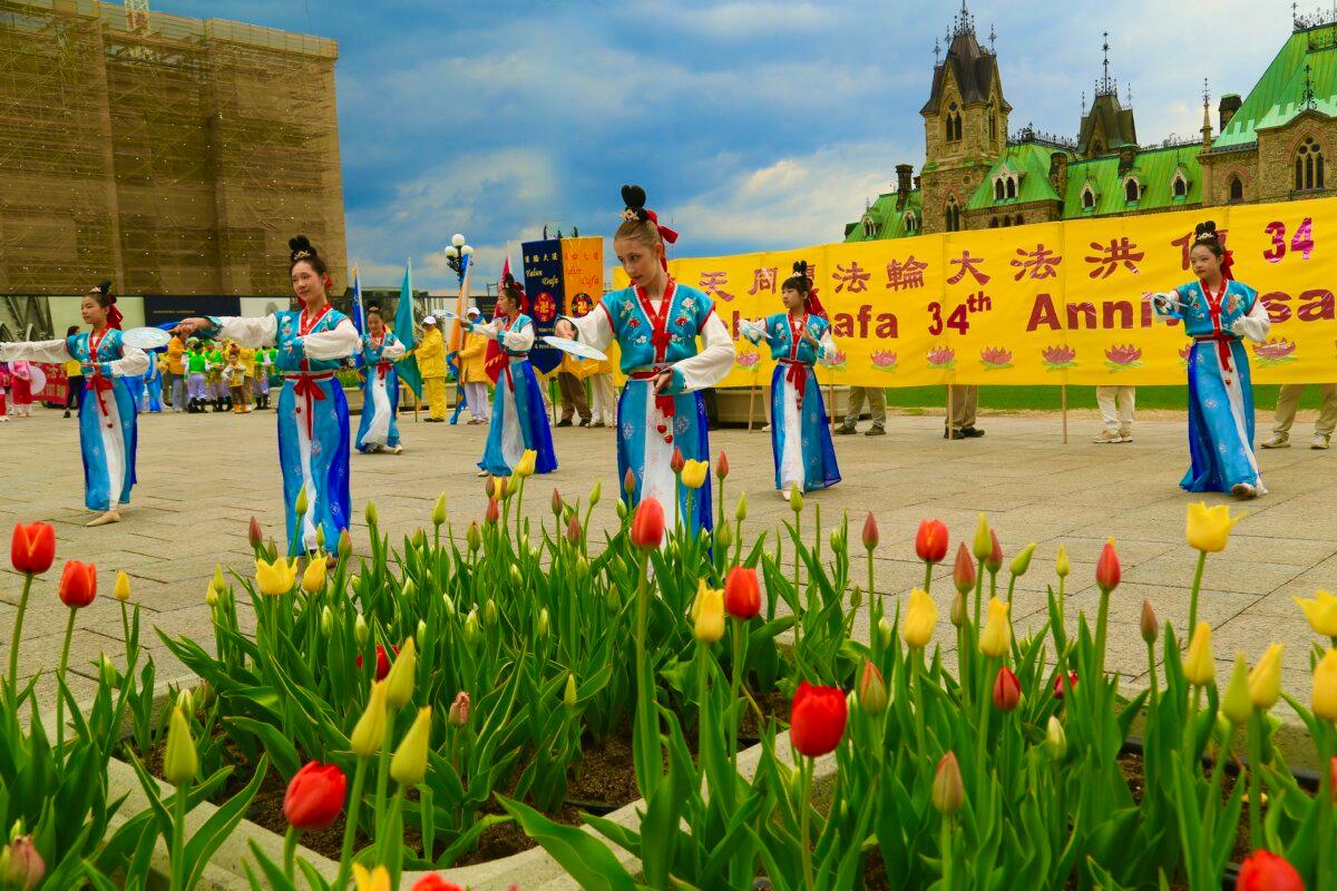 Young Falun Dafa practitioners hold a dance performance as part of activities to celebrate the World Falun Dafa Day on Parliament Hill, Ottawa, on May 5, 2026. (Jonathan Ren/The Epoch Times)
