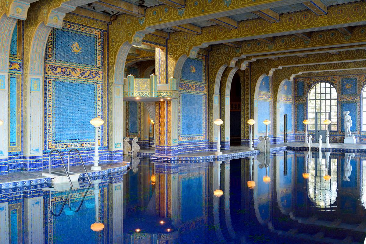 Inspired by ancient Roman bath and Byzantine architecture, the Roman Pool transcends mere recreation. Its walls and ceiling are blanketed in shimmering mosaic glass with real gold leaf fused between the layers, a technique drawn directly from late antique structures in Ravenna, Italy. The effect is less swimming pool than gilded chamber and more fitting for a Byzantine emperor than a California estate. (Alizada Studios/Shutterstock)