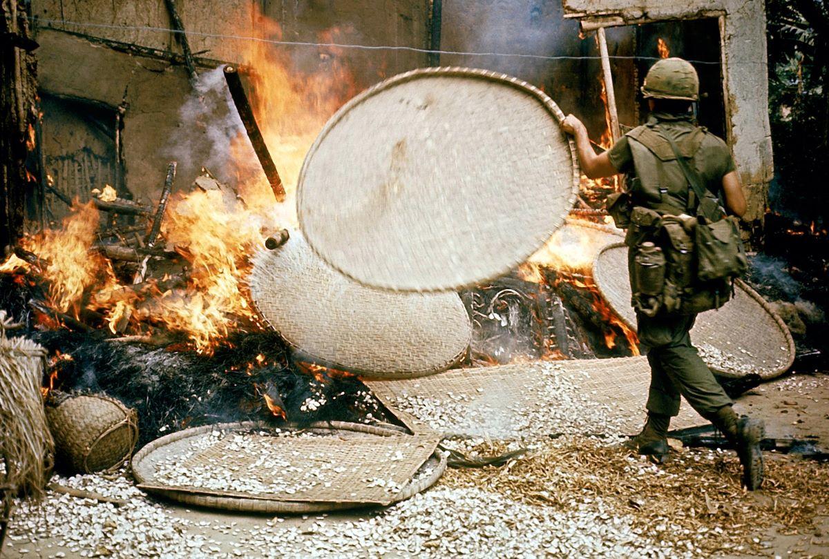 A U.S. soldier burning down a dwelling during the My Lai massacre. (Public Domain)