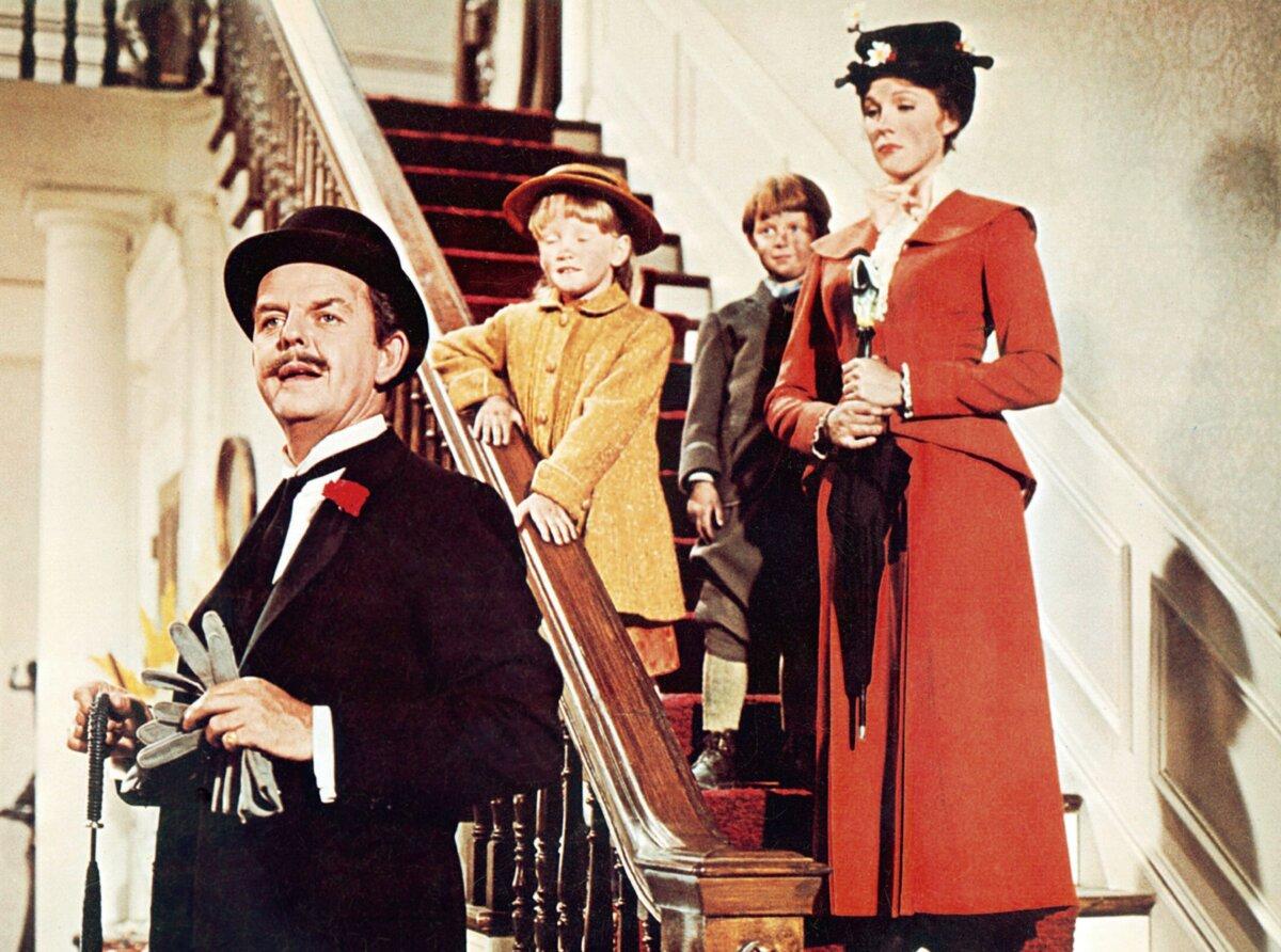(L–R) George Banks (David Tomlinson), Jane (Karen Dotrice), Michael (Matthew Garber), and Mary Poppins (Julie Andrews), in “Mary Poppins.” (Walt Disney Pictures/MovieStillsDB)