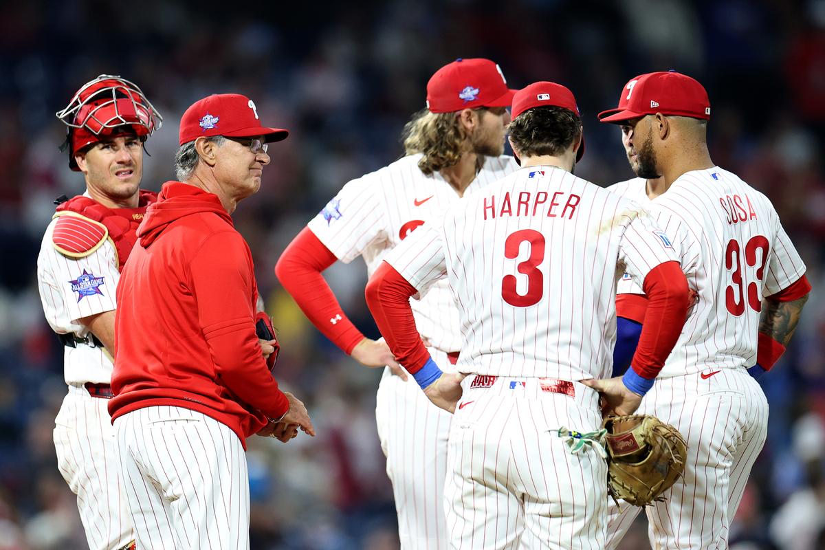 Don Mattingly, interim manager for the Philadelphia Phillies, stands on the mound with J.T. Realmuto (10), Alec Bohm (28), Bryce Harper (3) and Edmundo Sosa (33) during a pitching change in the seventh inning against the Athletics at Citizens Bank Park in Philadelphia on May 6, 2026. (Emilee Chinn/Getty Images)