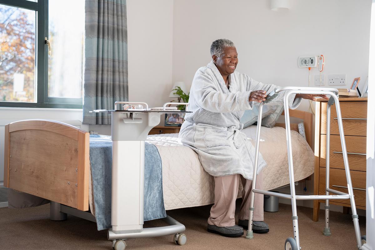 Bedroom design for aging in place prioritizes clear pathways, stable furniture, and adaptable layouts that support independence. (Cultura Creative/Getty Images)