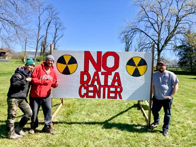 Members of Southern Ohio Responsible Development pose with a sign opposing a planned data center in Mount Orab, Ohio, in March 2026. Mount Orab, about 40 miles east of Cincinnati, is the latest target for a hyperscale data center. (Courtesy of Danei Edelen/Southern Ohio Responsible Development)