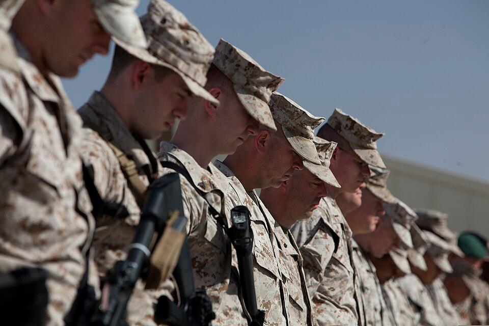 U.S. Marines bow their heads in a moment of silence during a Memorial Day ceremony at Camp Leatherneck, Helmand province, Afghanistan, May 27, 2013. (Public Domain)