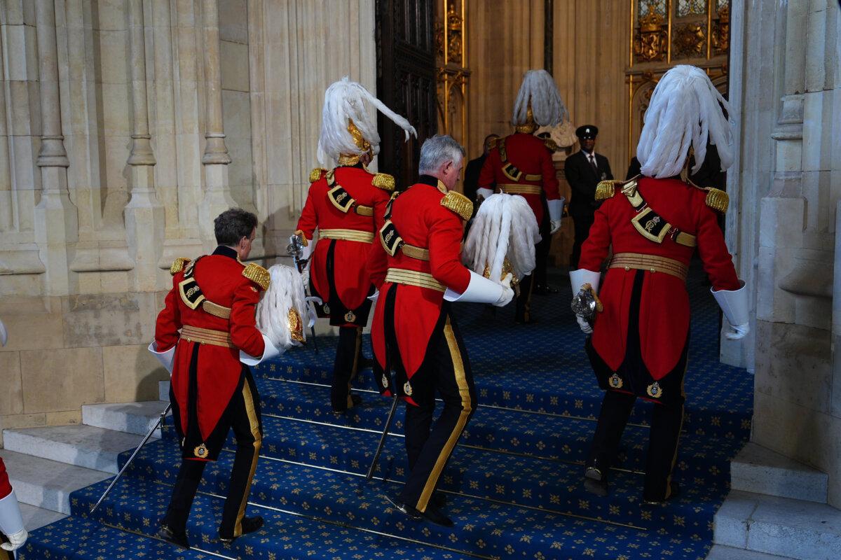 Members of the king's Body Guard of the Honorable Corps of Gentlemen arrive at the Sovereign's Entrance for the State Opening of Parliament in the House of Lords, in London on May 13, 2026. (Aaron Chown/AP)