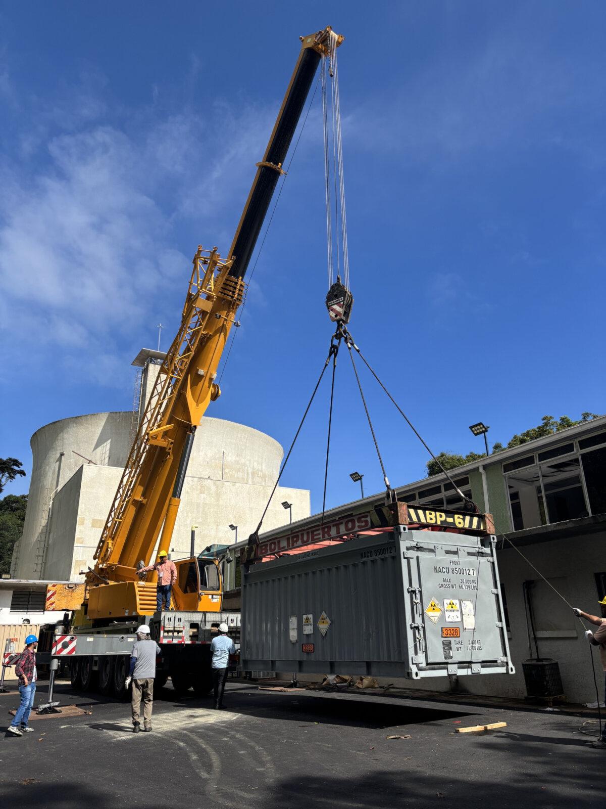 National Nuclear Security Administration technical experts oversee the loading of nuclear fuel into the specialized spent nuclear fuel cask during a special operation in Venezuela. (NNSA)