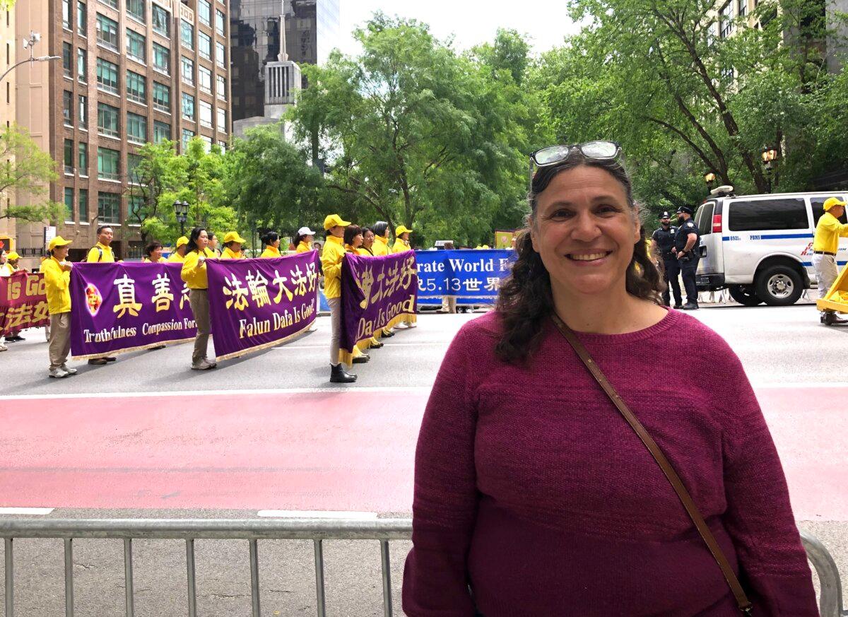New Yorker Ariana Galesi watched the Falun Dafa Day parade in Midtown Manhattan on May 13, 2026. (Lin Nan/The Epoch Times)