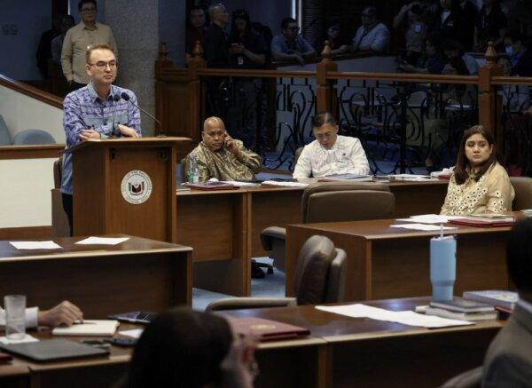 Shortly before the shooting, Senator Ronald dela Rosa (C) takes a phone call during a session at the Senate, in Pasay City, Metro Manila, Philippines, on May 13, 2026. (Eloisa Lopez/Reuters)