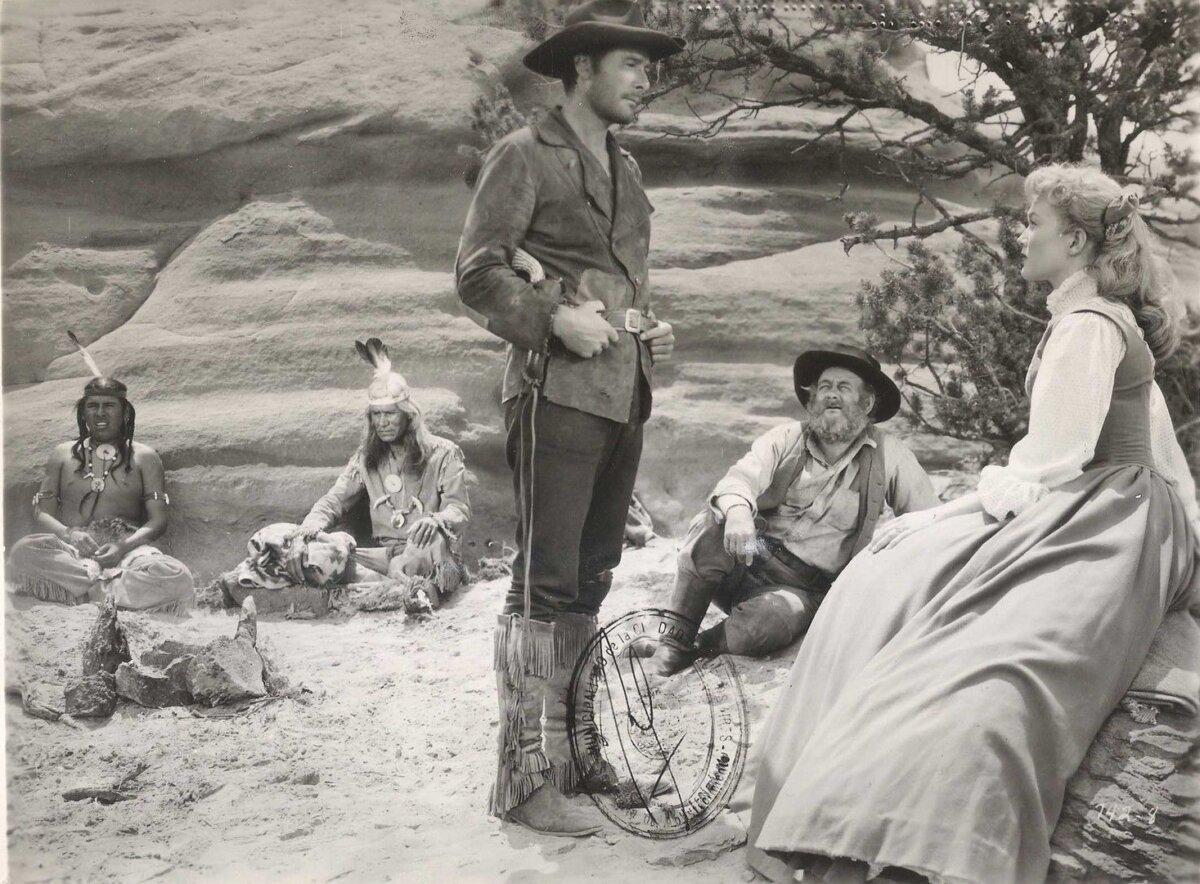 (L–R) Man Dog (Nakai Snez), and Capt. Lafe Barstow (Errol Flynn), Gil Craigie (Chubby Johnson), and Johanna Carter (Patrice Wymore), in “Rocky Mountain.” (Warner Bros. Pictures)