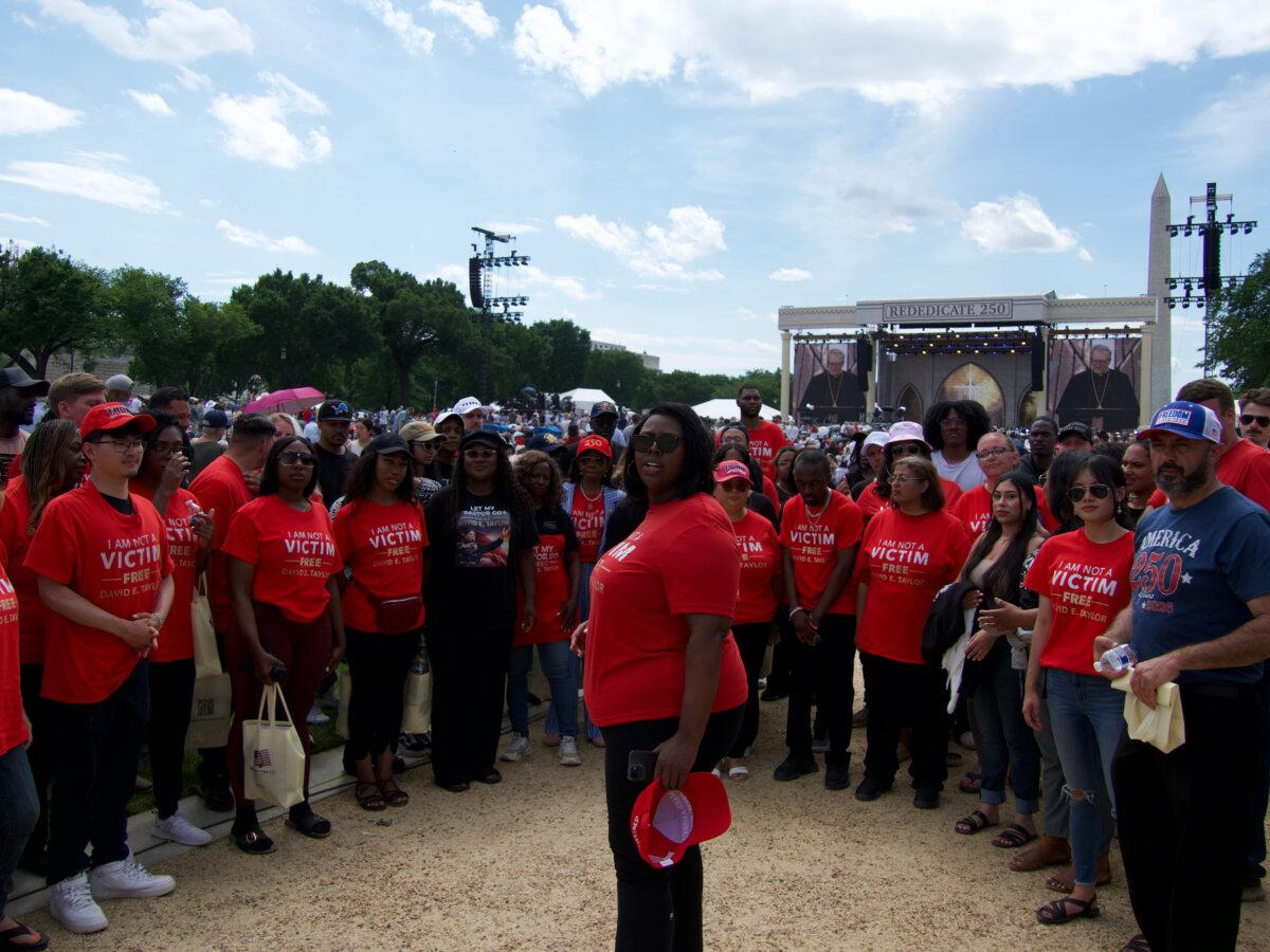 Kea Jones, center, and supporters of the Kingdom of God Church gather on the National Mall for the Rededicate 250 celebration in Washington on May 17, 2026. (Travis Gillmore/The Epoch Times)