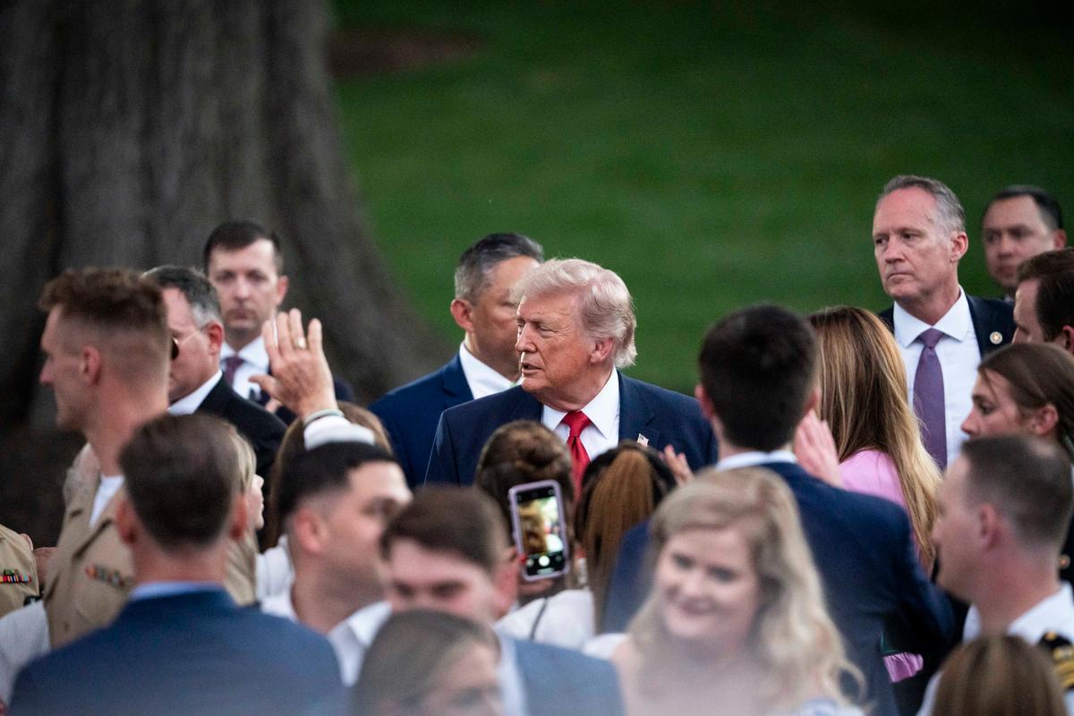 President Donald Trump talks with guests during the annual Congressional Picnic on the South Lawn of the White House on May 19, 2026. (Madalina Kilroy/The Epoch Times)