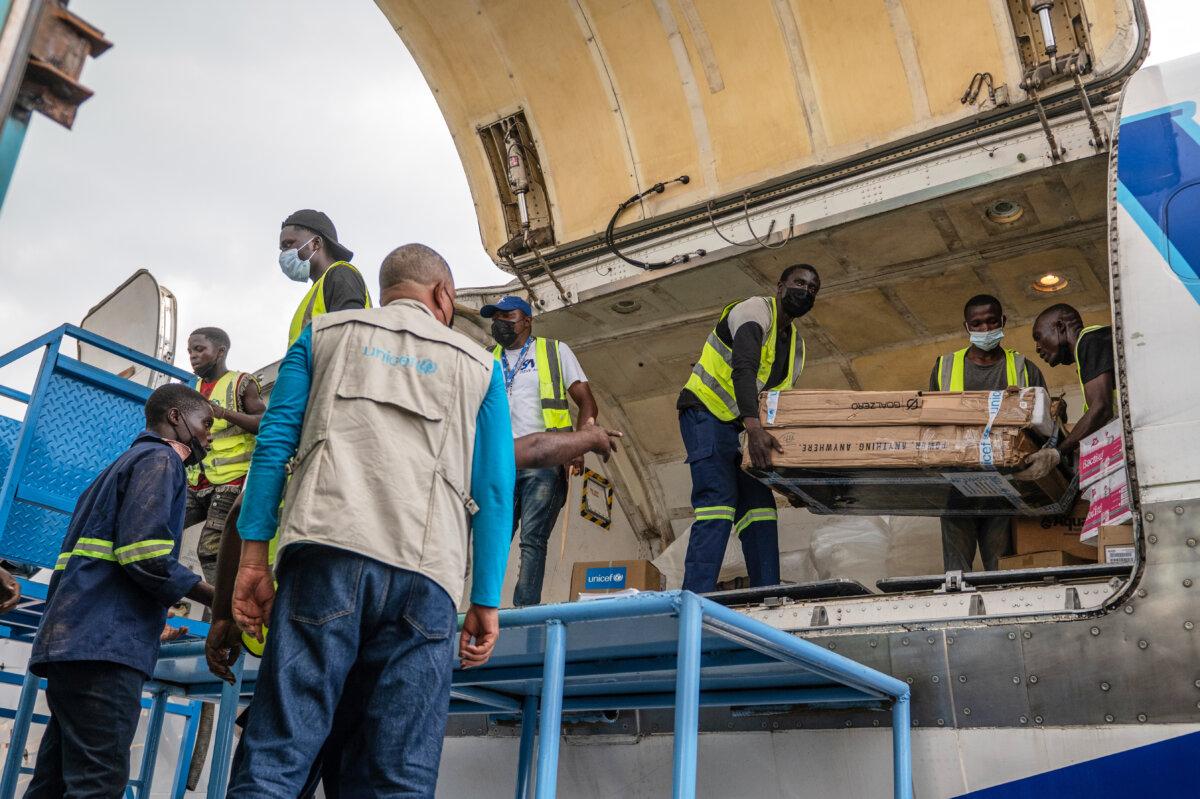 People offload a shipment of more than 15 tons of supplies donated by UNICEF as part of the response to the Ebola virus outbreak, at Bunia National Airport in Bunia, Congo, on May 19, 2026. (Moses Sawasawa/AP Photo)