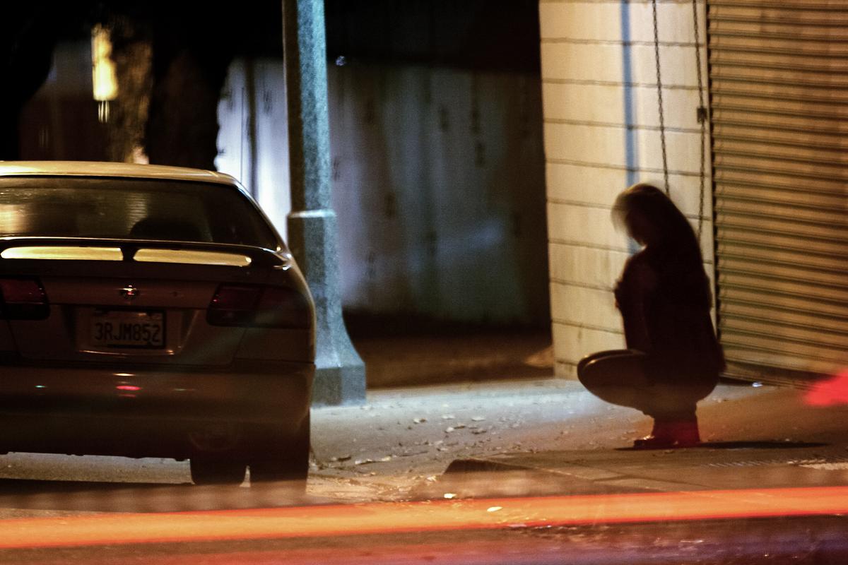 While sex trafficking is different from prostitution, which is a criminal offense, sex traffickers may force their victims to work in street prostitution. Sex traffickers control their victims in a variety of ways from emotional manipulation to violence. (David McNew/Getty Images)