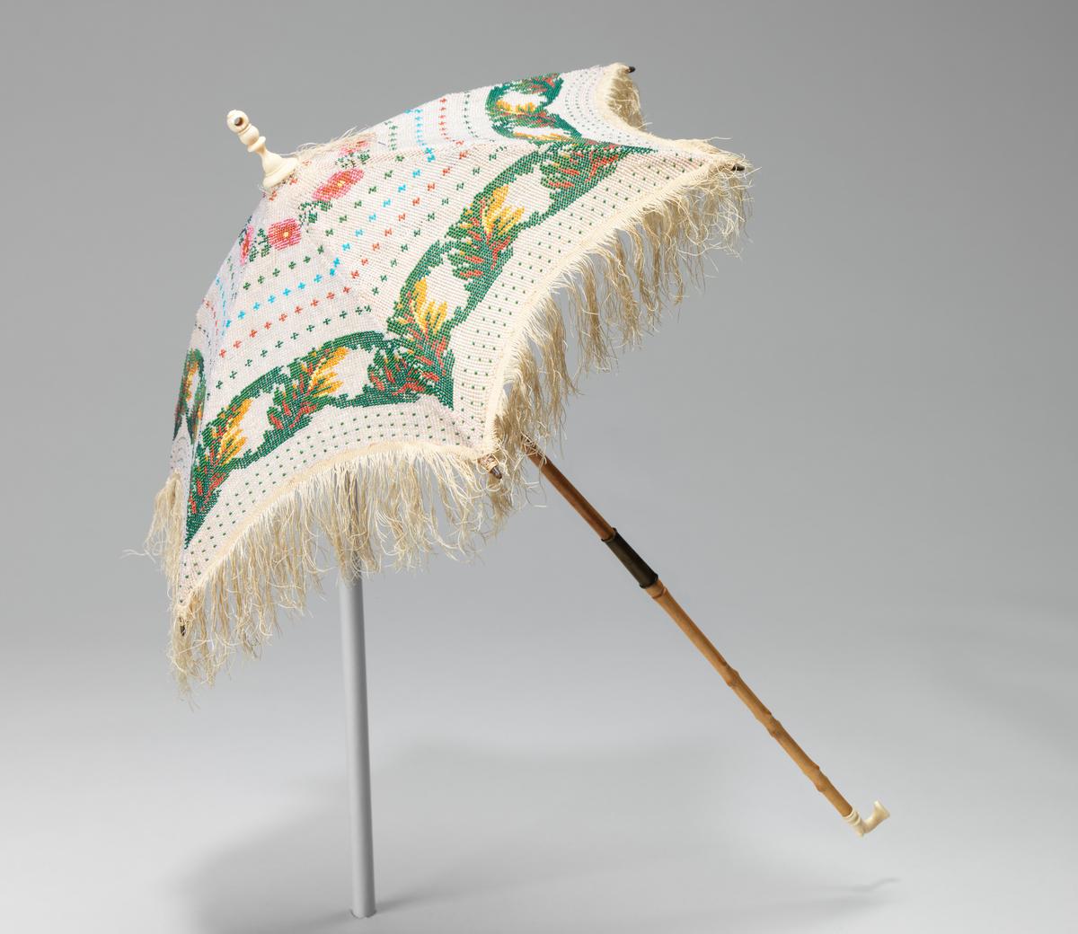 This American parasol from 1870 was made to be noticed. Constructed from silk, glass, wood, metal, ivory, and linen, it was a pure display that caught the light with every turn of the wrist. Brooklyn Museum Costume Collection at the Metropolitan Museum of Art, New York City. (Public Domain)