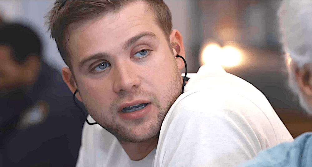 Niki White (Leo Woodall) wearing his ear gear in a bar, in "Tuner." (Black Bear Pictures)