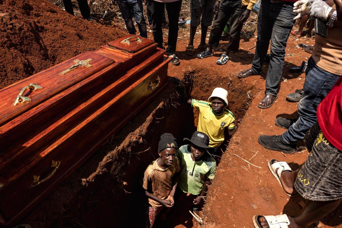 People attend the burial of an Ebola victim at a cemetery in Mongbwalu, Ituri province, Congo, during the Ebola outbreak on May 20, 2026. (Michel Lunanga/Getty Images)