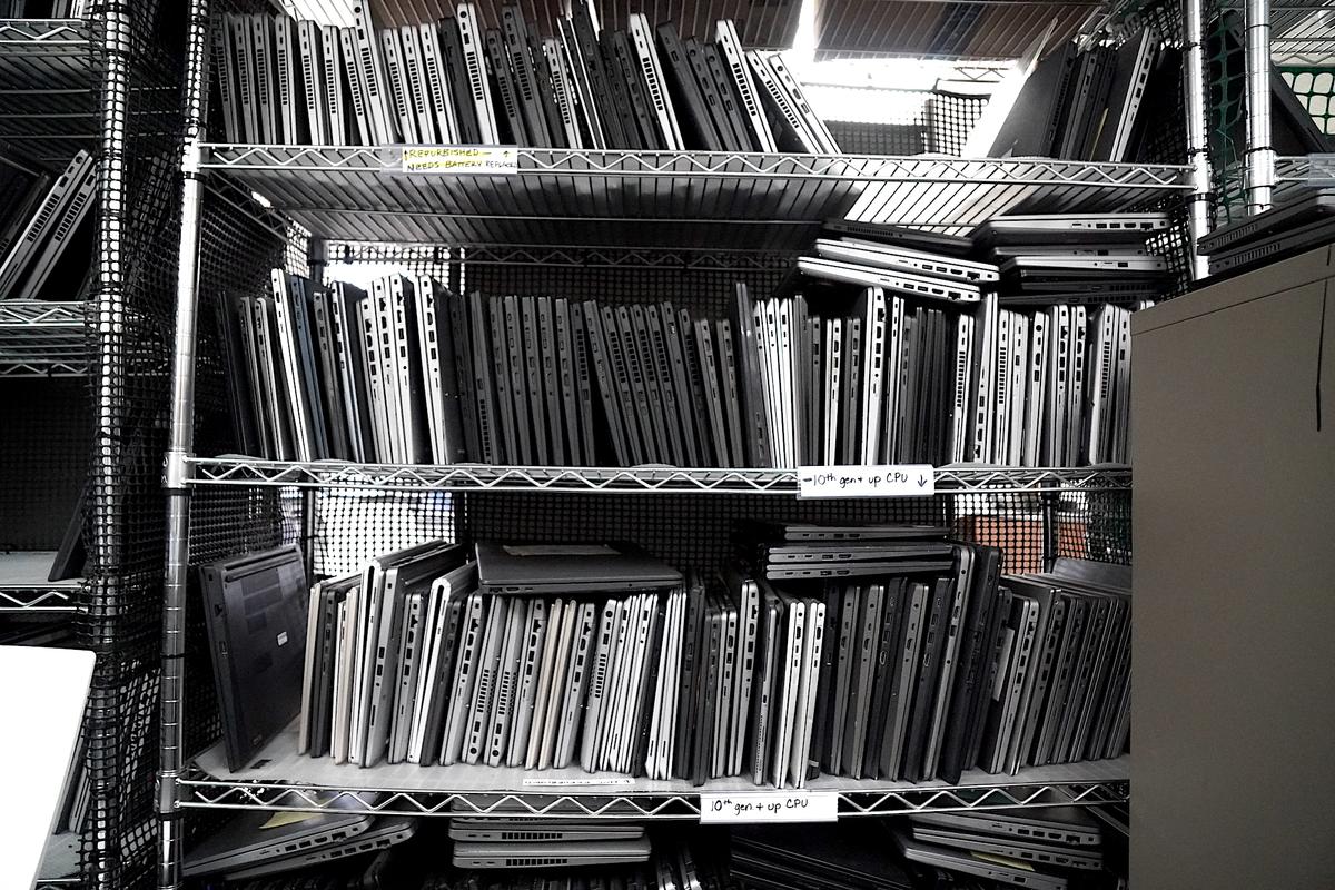 Old laptops and Chromebooks waiting to get a second life at Arizona StRUT in Tempe, Ariz., on May 20, 2026. (Allan Stein/The Epoch Times)
